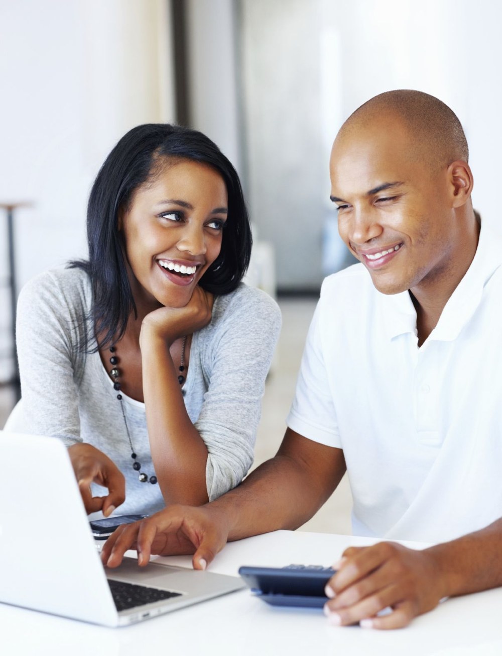 Two professionals reviewing learning materials together at a laptop