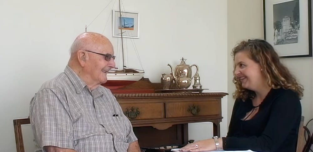 A clinician speaking with an older adult, from archival AMPS course material